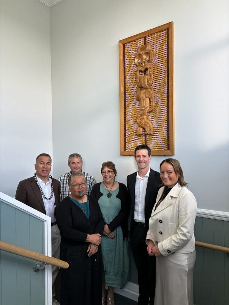 Guests at the Stage 1B opening of the St Joseph’s Māori Girls’ College hostel, beside a carved pou
