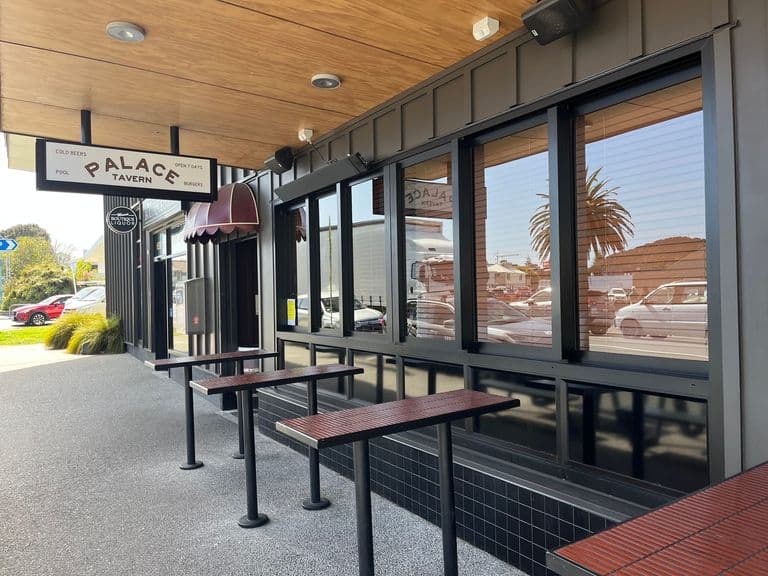 Completed hospitality tenancy fitout at the Palace Tavern, with dark cladding, timber soffit and street-front leaners