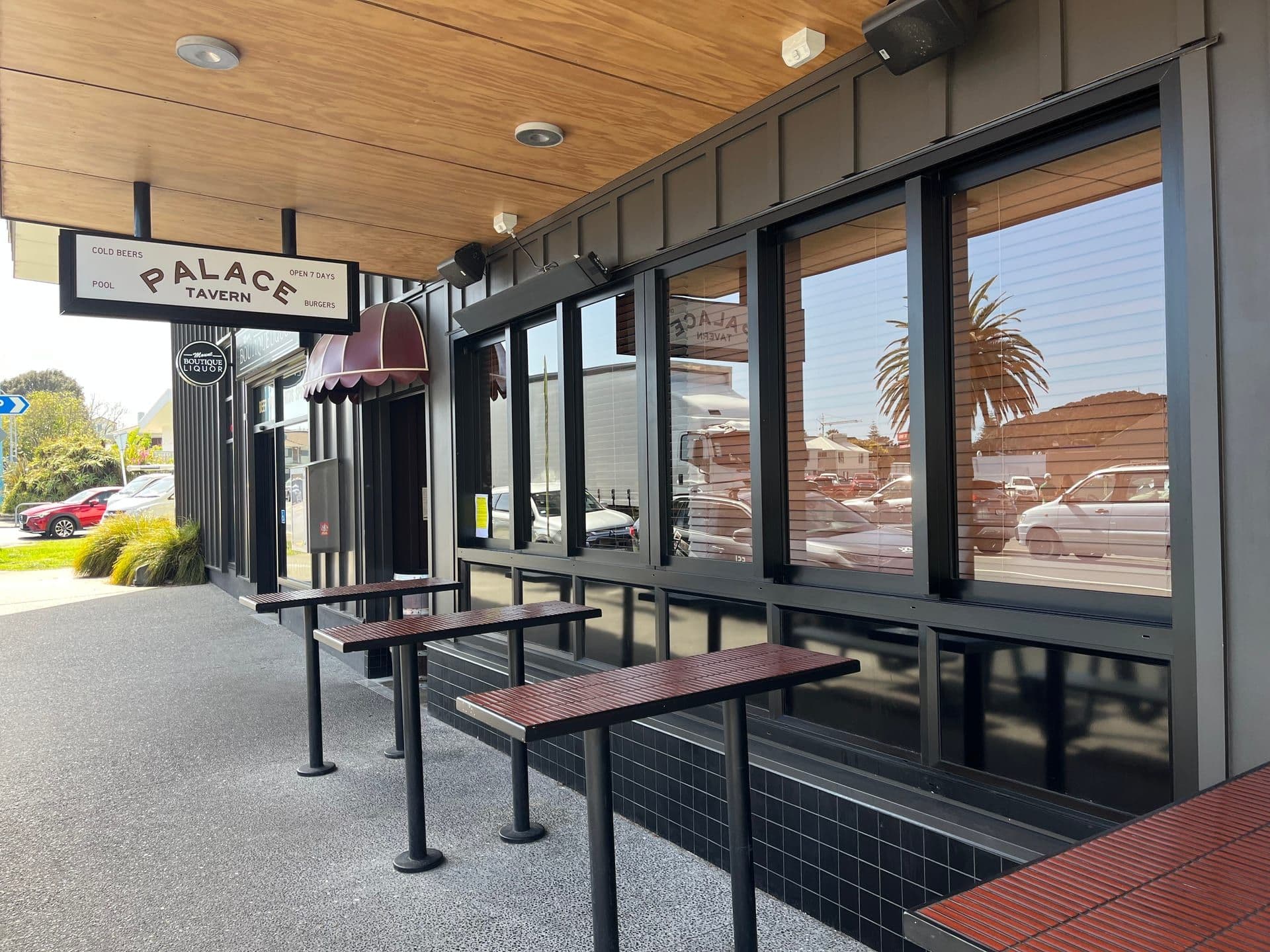 Completed hospitality tenancy fitout at the Palace Tavern, with dark cladding, timber soffit and street-front leaners